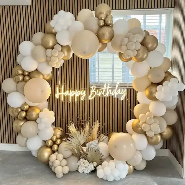 Birthday party with green, gold and white balloon decorations